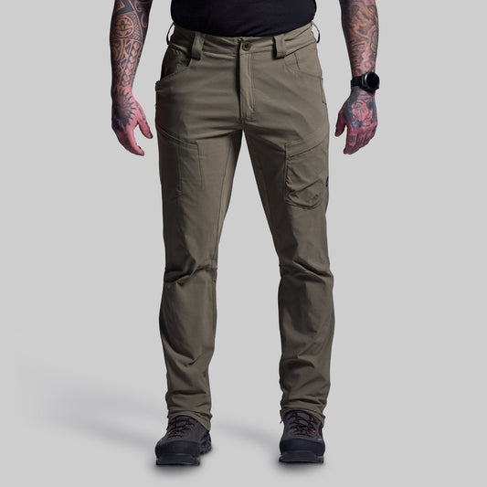 Person wearing green outdoor pants on a gray background