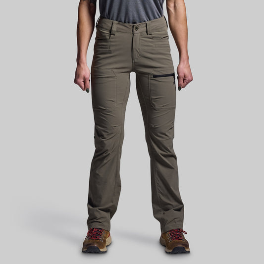 Person wearing green pants on a gray background