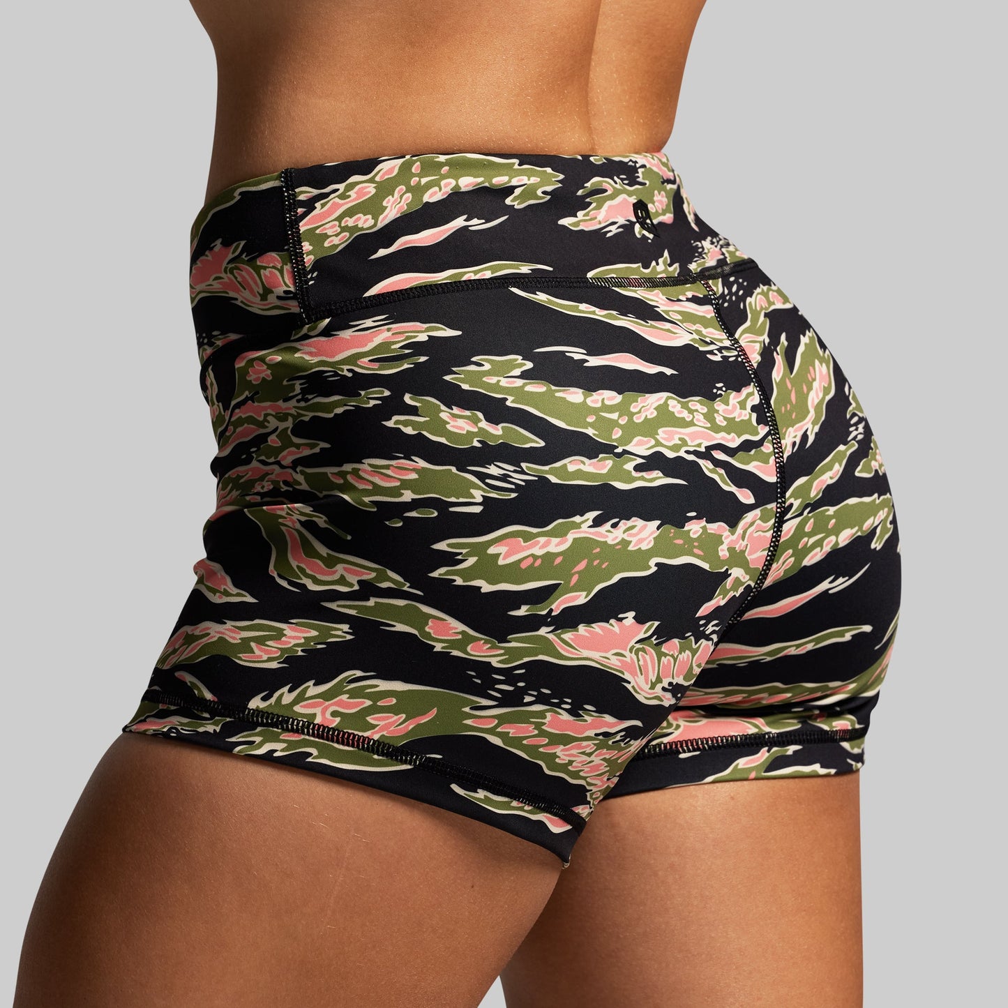 Mid rise shorts with a camouflage pattern on a gray background