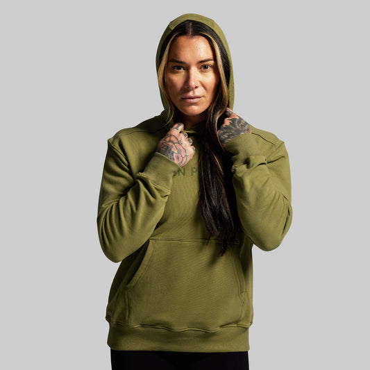 Person wearing a green hoodie with a visible brand logo on a gray background