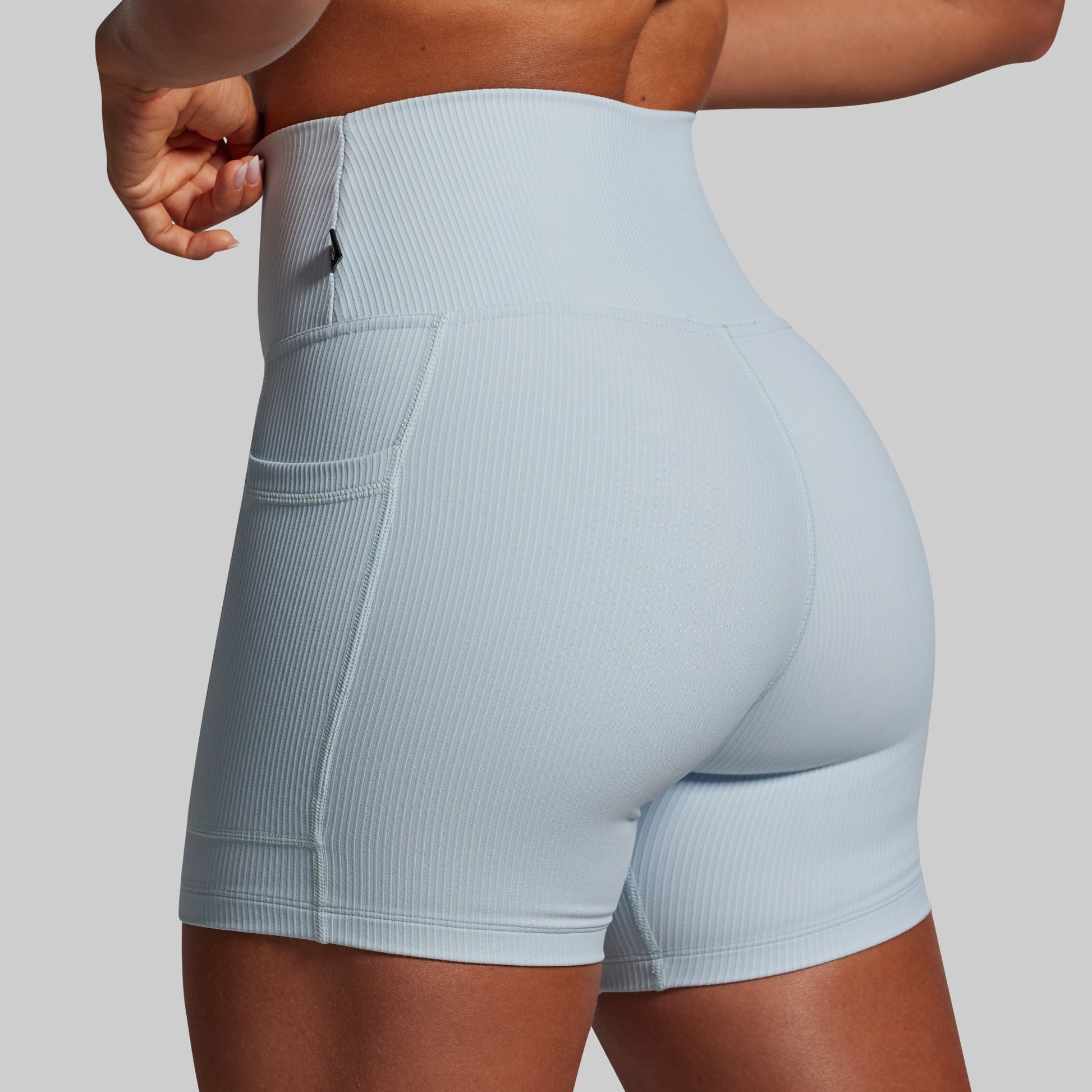 Light blue athletic shorts worn by a person on a plain background