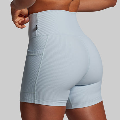 Light blue athletic shorts worn by a person on a plain background