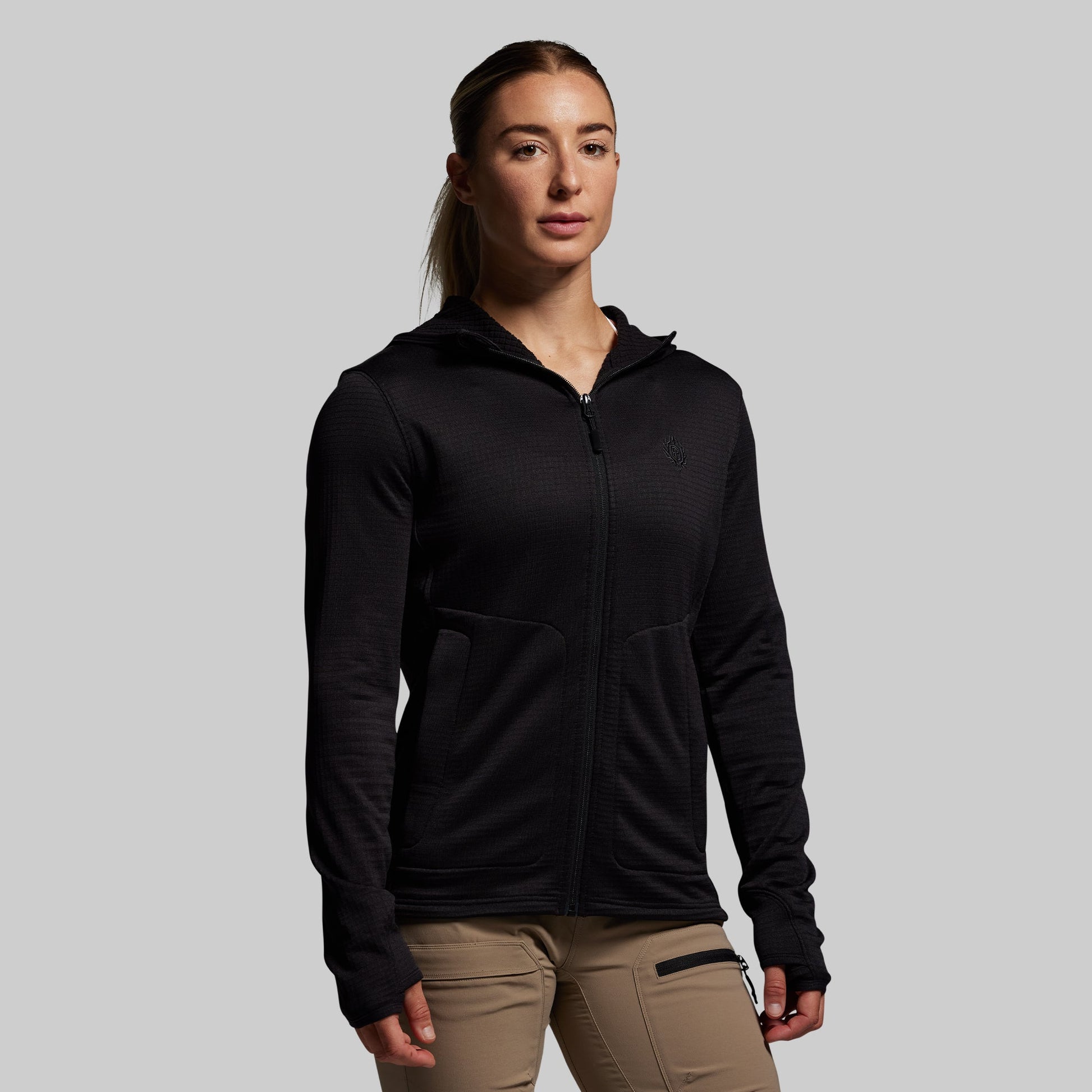 Person wearing a black hoodie on a gray background