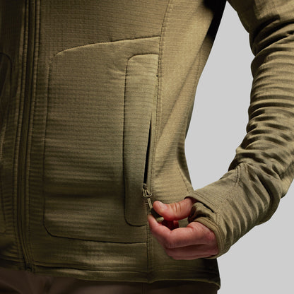 Close-up of a person wearing a green hoodie with a pocket and zipper.
