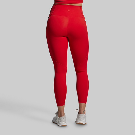 Red leggings worn by a person on a gray background