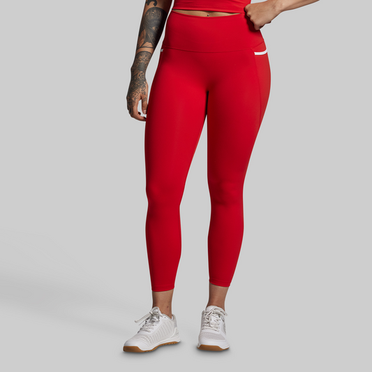 Person wearing red leggings on a gray background