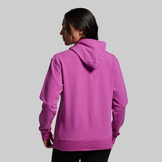 Person wearing a purple hoodie on a gray background