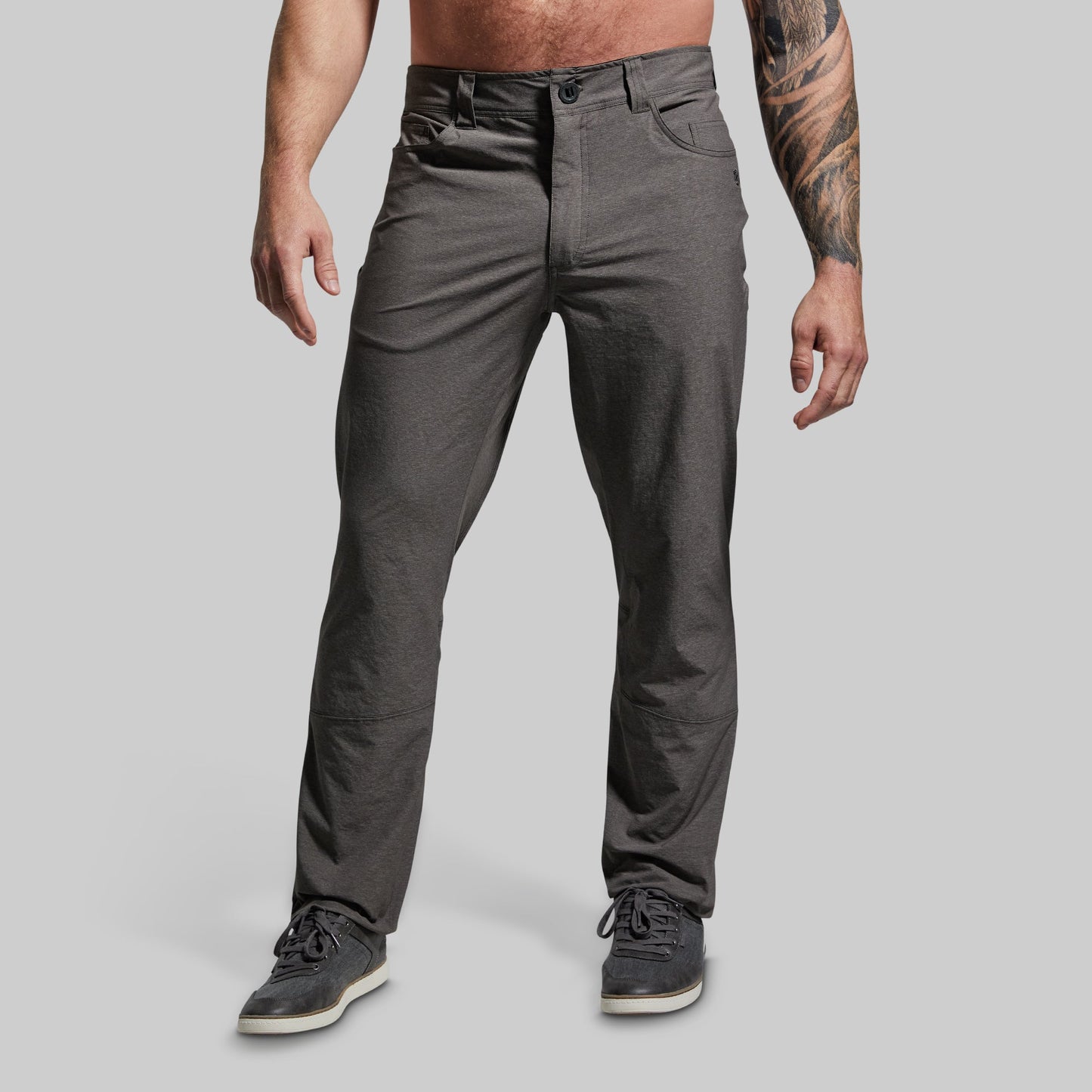 Person wearing gray pants on a plain background